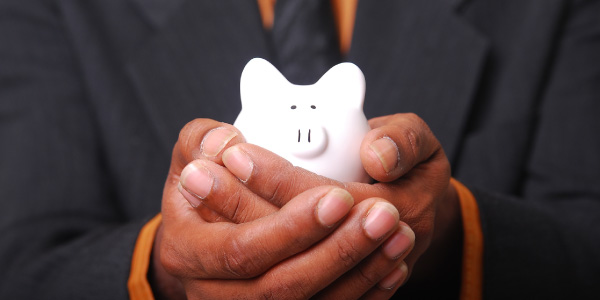 hands holding small piggy bank