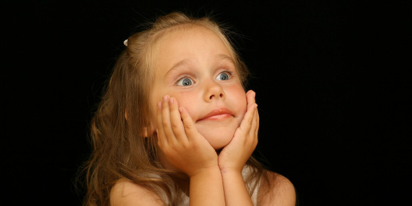 young girl looking surprised and interested